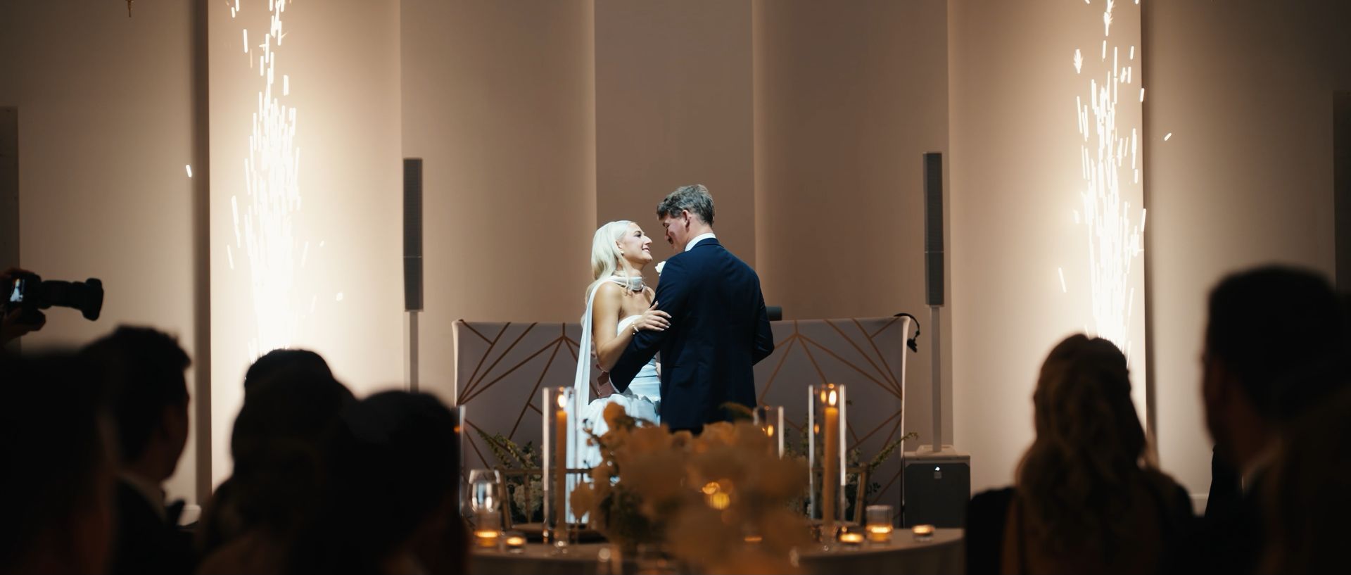Ashley and Luke sharing their first dance between cold sparklers