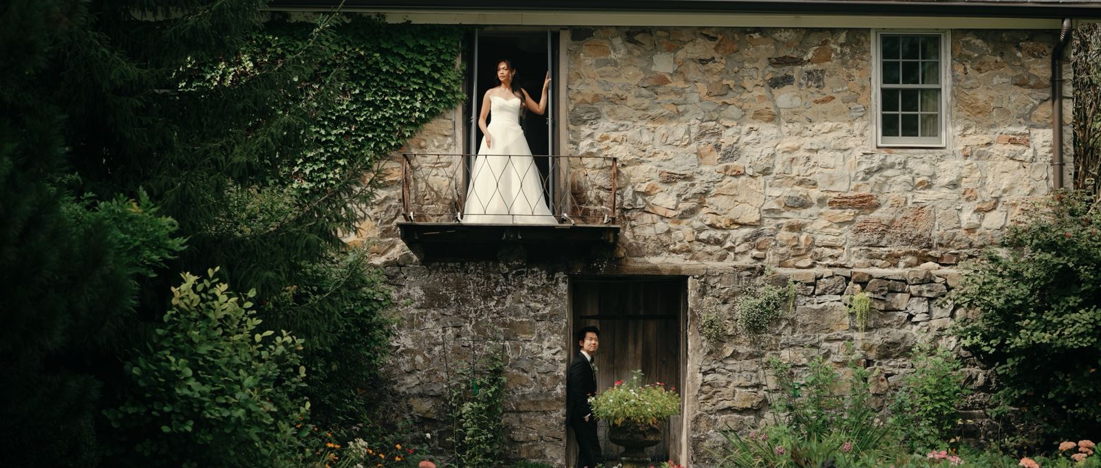 Caroleen on an ivy covered stone balcony as Ricky waits in the garden below