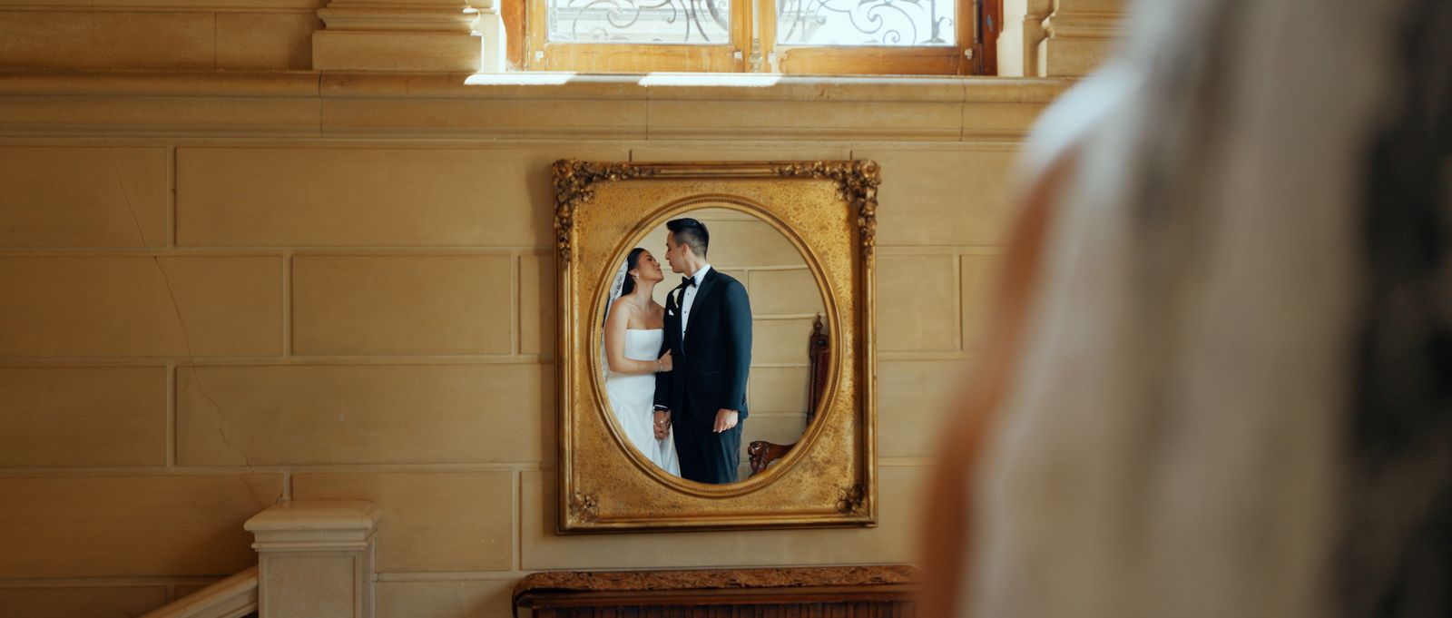 Carolina and Adrian reflected in a gilded mirror at Aldrich Mansion