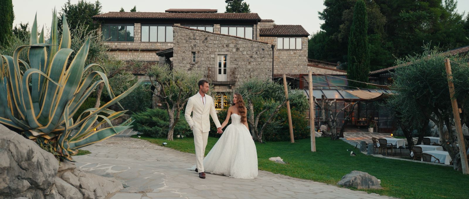 Sara and Taylor walking past the stone buildings at AquaPetra