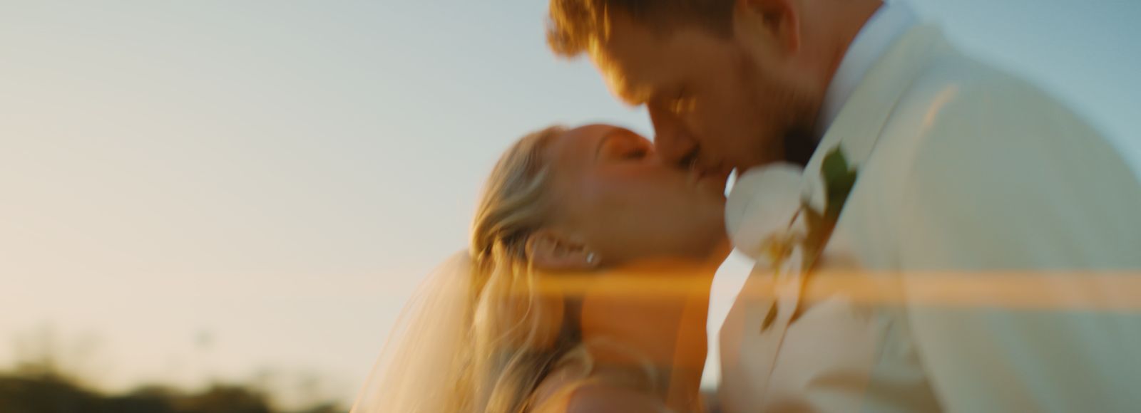Summer and Brant kissing in golden hour light